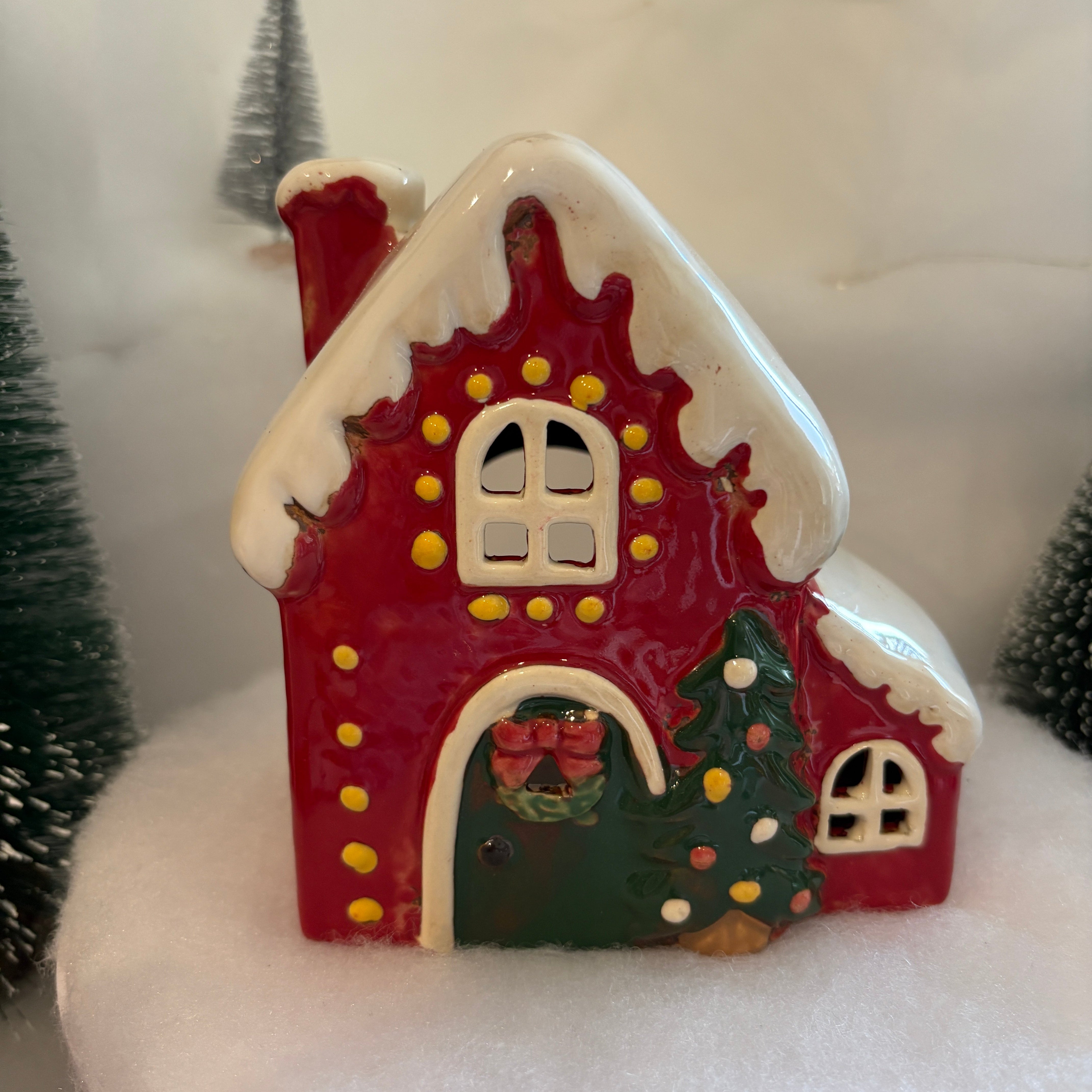 Decorative red house ornament on a white background